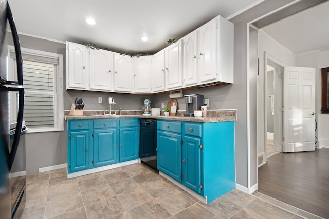 kitchen featuring blue cabinetry, white cabinetry, and sink