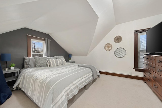 carpeted bedroom featuring lofted ceiling