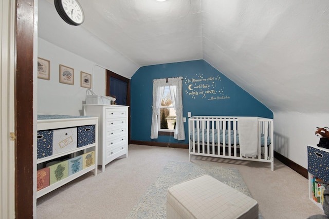 bedroom featuring light colored carpet and lofted ceiling