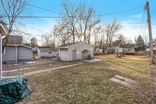 view of yard with a patio area, an outdoor structure, and a garage