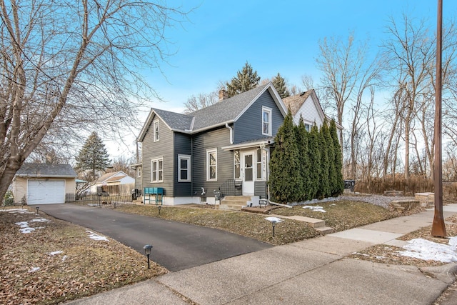 view of front of home with a garage and an outdoor structure