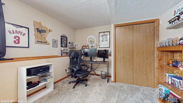 carpeted office space with a textured ceiling