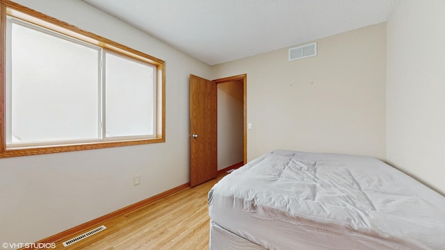 bedroom with light hardwood / wood-style floors