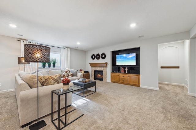 living area with baseboards, recessed lighting, a tile fireplace, and light colored carpet