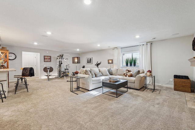 living room featuring light carpet, baseboards, a textured ceiling, and recessed lighting