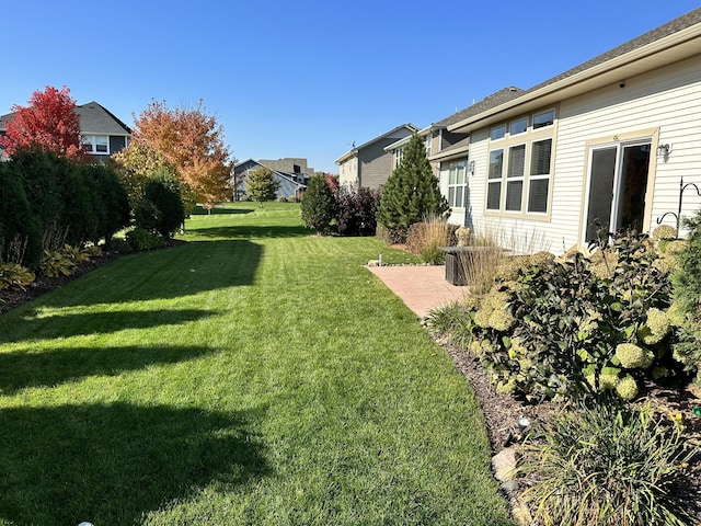 view of yard with a residential view and a patio area