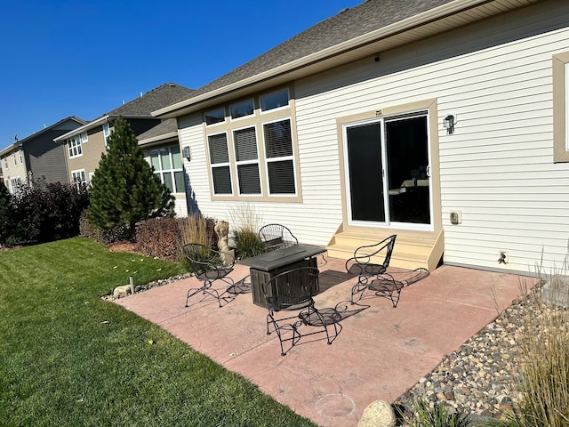 back of property featuring entry steps, a patio area, and a yard