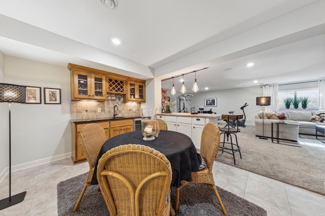 dining room featuring light tile patterned floors, baseboards, light colored carpet, wet bar, and recessed lighting