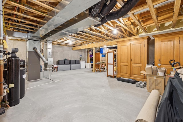 unfinished basement featuring heating unit