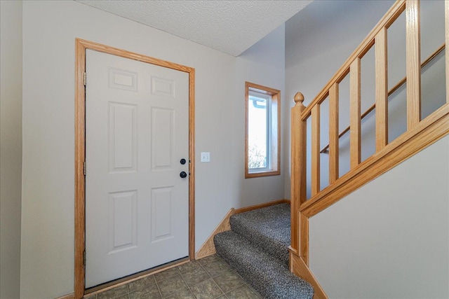 foyer with a textured ceiling