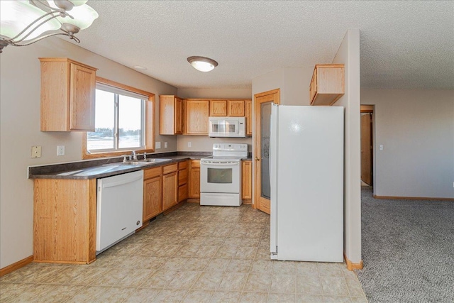 kitchen featuring sink, white appliances, and a textured ceiling