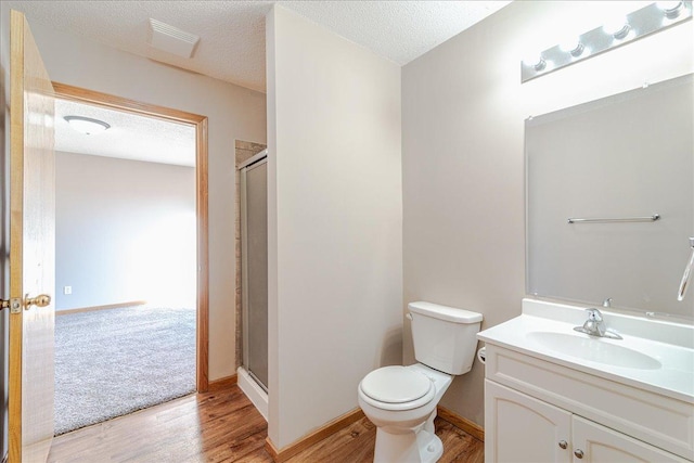 bathroom featuring a textured ceiling, vanity, and hardwood / wood-style flooring