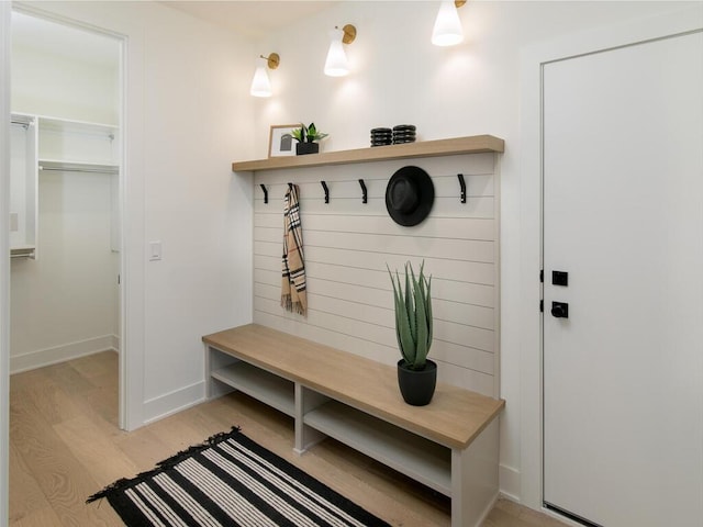 mudroom featuring light wood-style flooring and baseboards