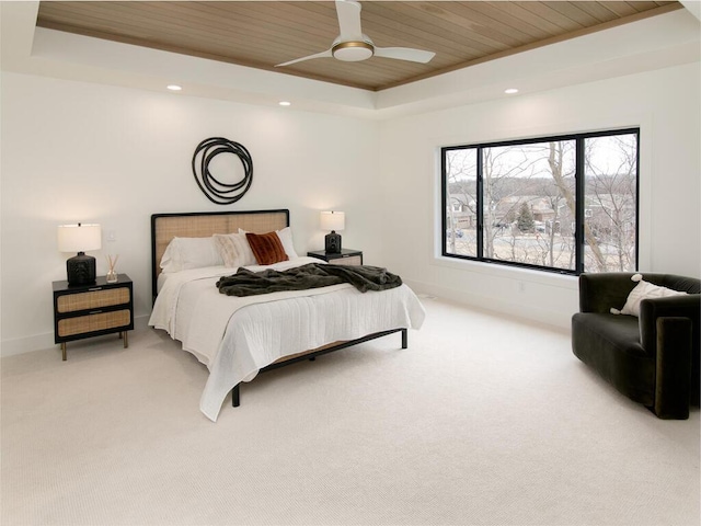 bedroom featuring baseboards, a raised ceiling, light colored carpet, wood ceiling, and recessed lighting