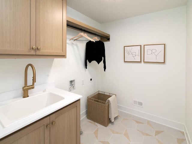 laundry area featuring cabinet space, baseboards, hookup for an electric dryer, washer hookup, and a sink