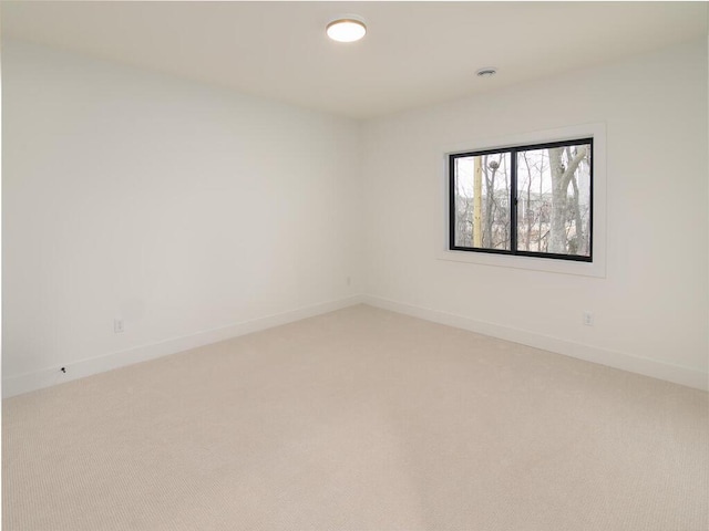 empty room with light carpet and baseboards