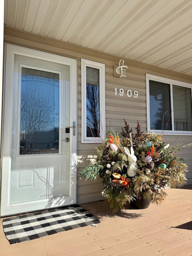 view of exterior entry featuring covered porch