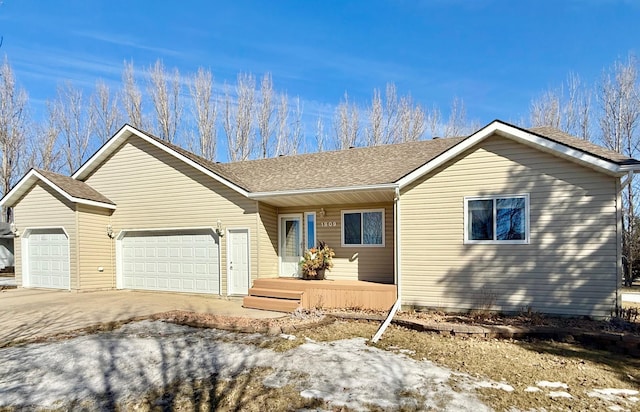 single story home with a garage, concrete driveway, and roof with shingles