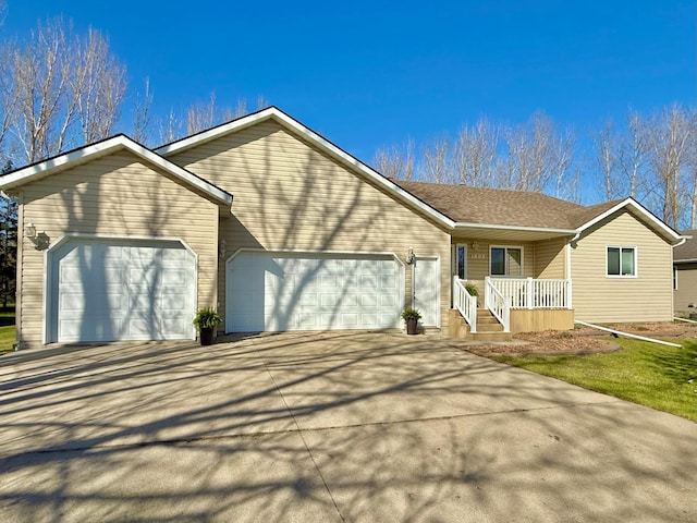ranch-style house with a garage, driveway, and covered porch