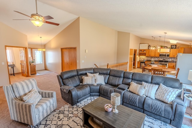 living room featuring a ceiling fan, light colored carpet, and high vaulted ceiling