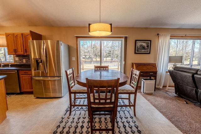 dining space featuring light tile patterned floors and a textured ceiling