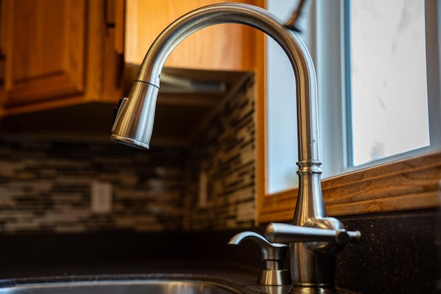 kitchen view of a sink and brown cabinets