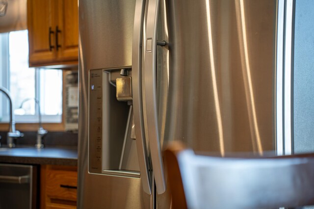 kitchen view of brown cabinetry and stainless steel appliances