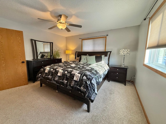 bedroom with carpet floors, a ceiling fan, a textured ceiling, and baseboards