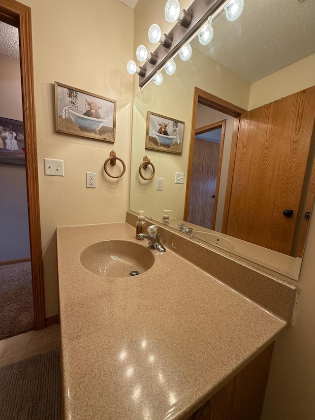 bathroom featuring vanity and a textured ceiling