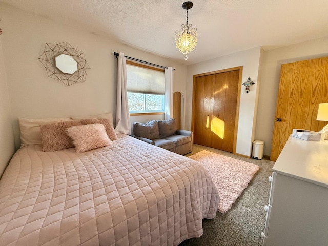 bedroom featuring a closet, light carpet, and a textured ceiling