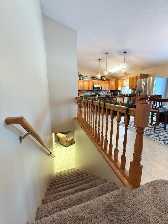 stairway with tile patterned floors