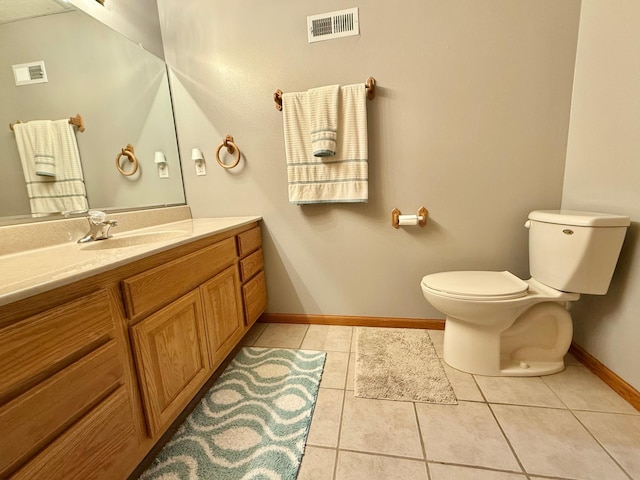 bathroom featuring toilet, baseboards, tile patterned flooring, and vanity