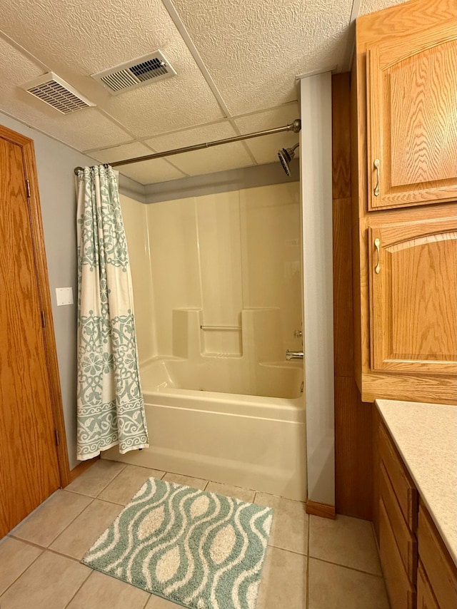 full bath featuring tile patterned floors, shower / bath combination with curtain, and vanity