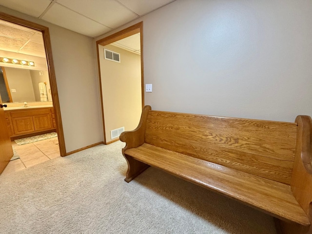 living area with light colored carpet and baseboards