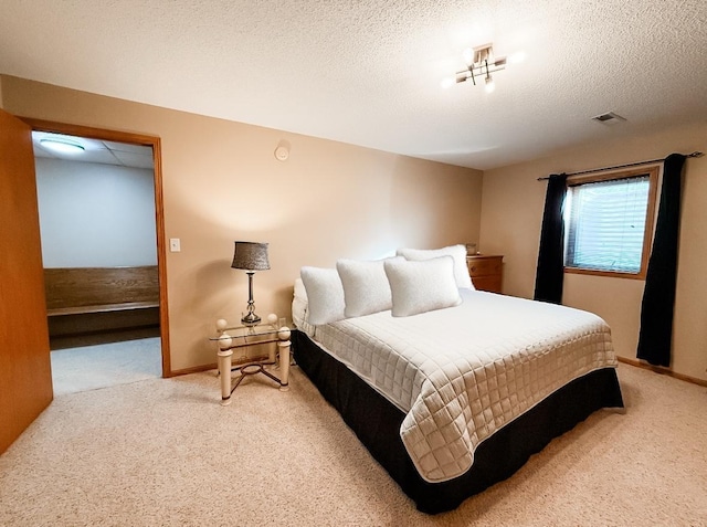 bedroom with carpet, a textured ceiling, and baseboards