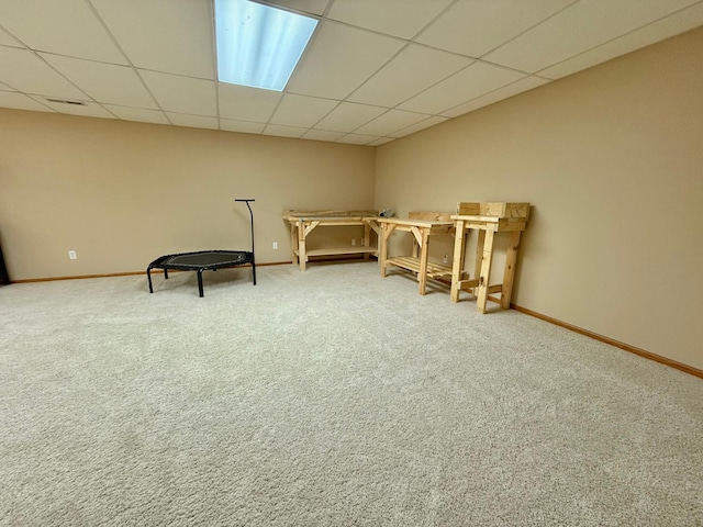 unfurnished room with baseboards, carpet flooring, and a paneled ceiling