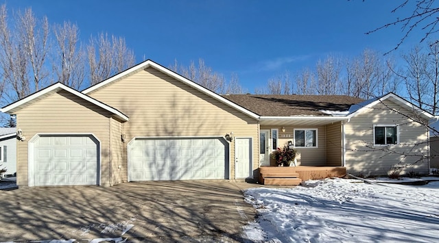 ranch-style house featuring a garage and driveway