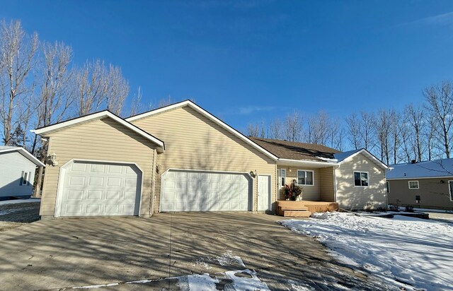 single story home with a garage and driveway