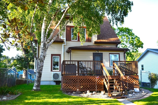 back of property featuring ac unit, a deck, and a yard