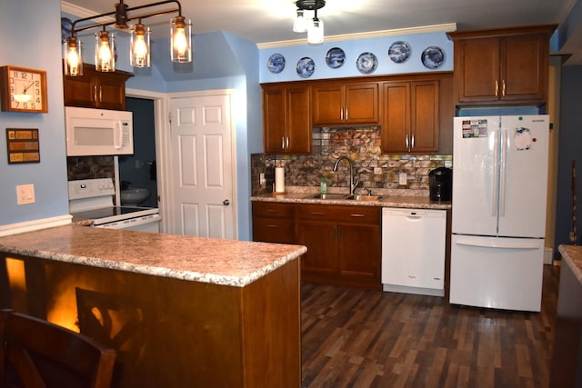 kitchen featuring white appliances, sink, hanging light fixtures, decorative backsplash, and kitchen peninsula