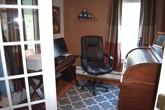 home office featuring wood-type flooring and baseboard heating