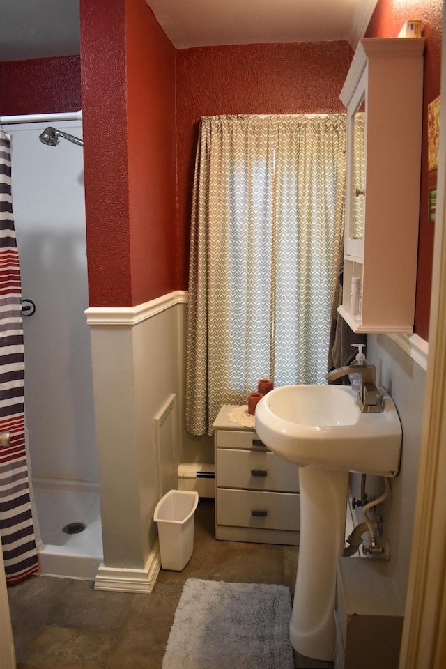 bathroom with a shower with shower curtain and a baseboard heating unit