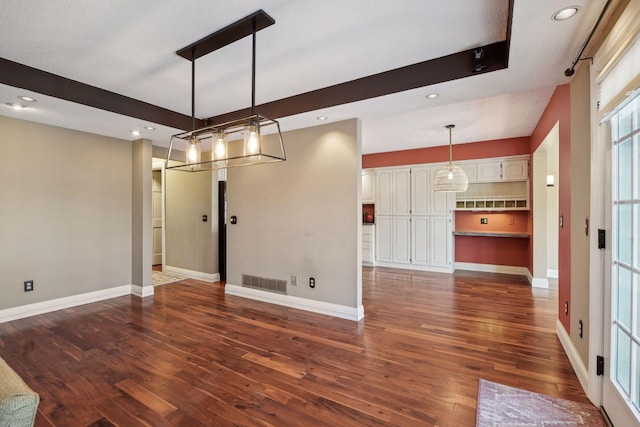 unfurnished dining area with dark wood-type flooring