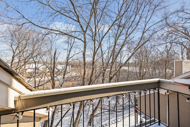 view of snow covered back of property