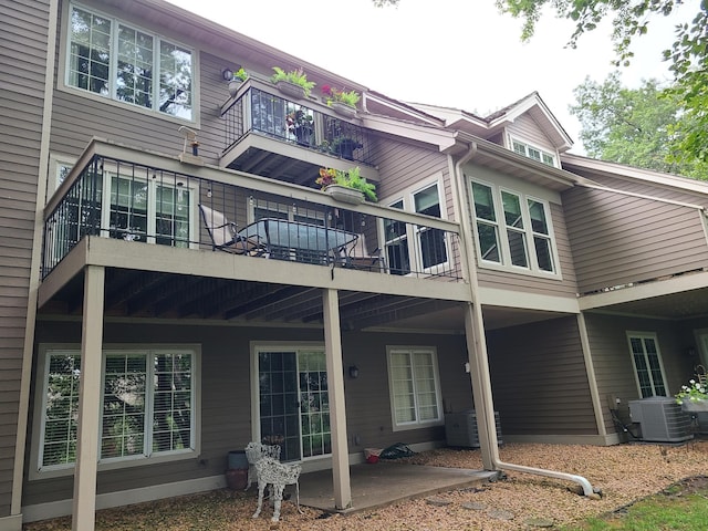 rear view of property featuring central air condition unit and a patio