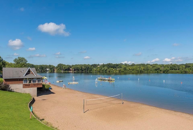 view of home's community with a water view and volleyball court