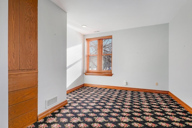 unfurnished room featuring carpet