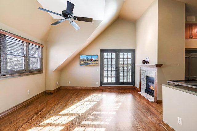 unfurnished living room with ceiling fan, wood-type flooring, french doors, and lofted ceiling