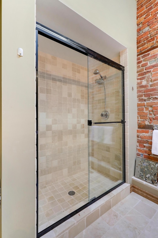 bathroom with a shower with door