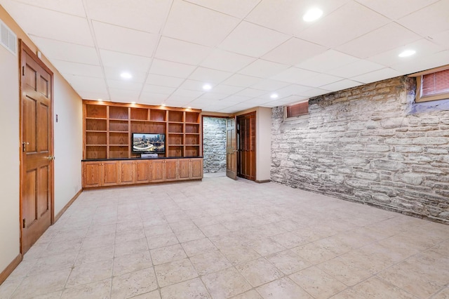 unfurnished living room featuring built in shelves